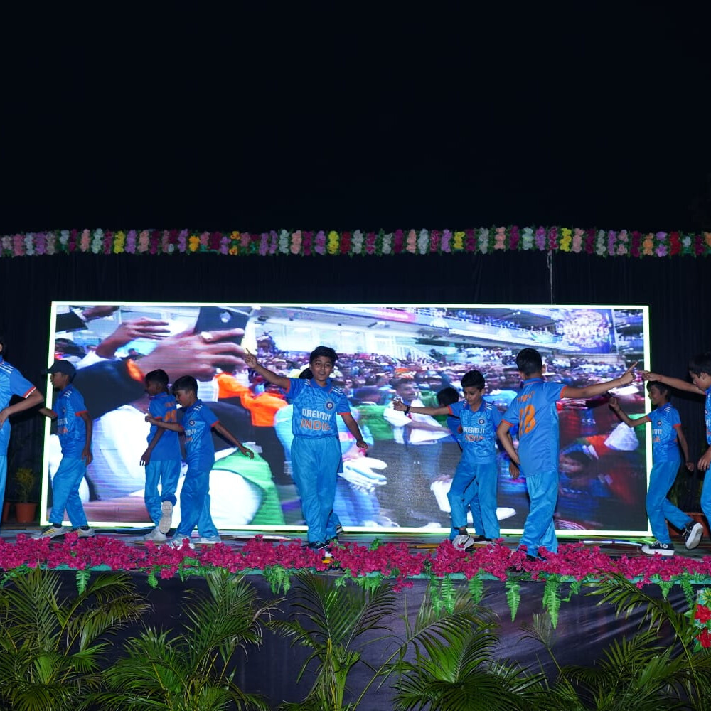 Students performing musical pieces on stage with a live audience at the school music concert.