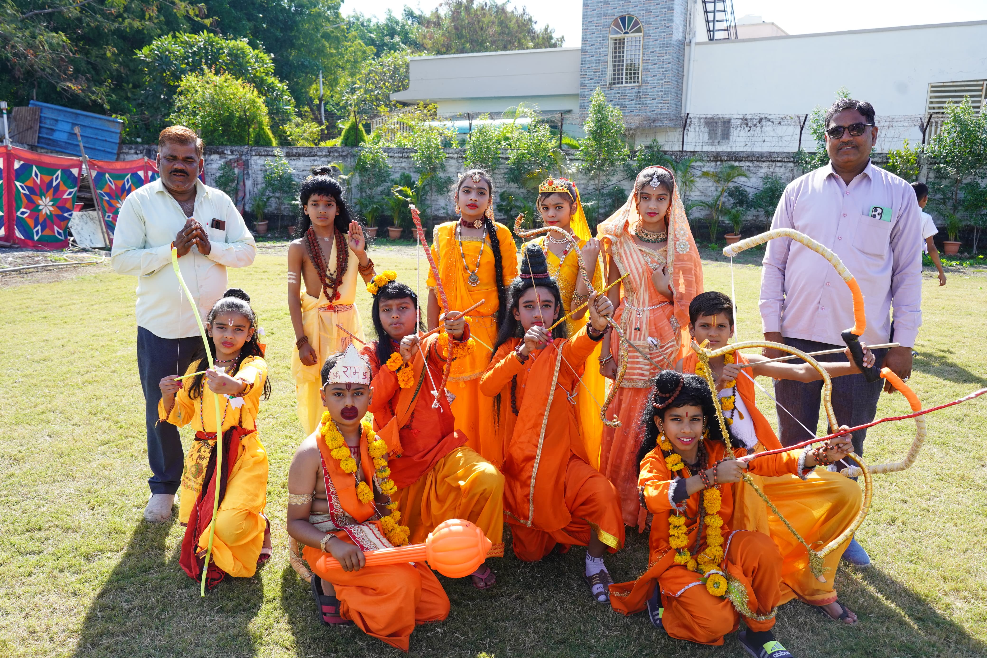 Students performing musical pieces on stage with a live audience at the school music concert.
