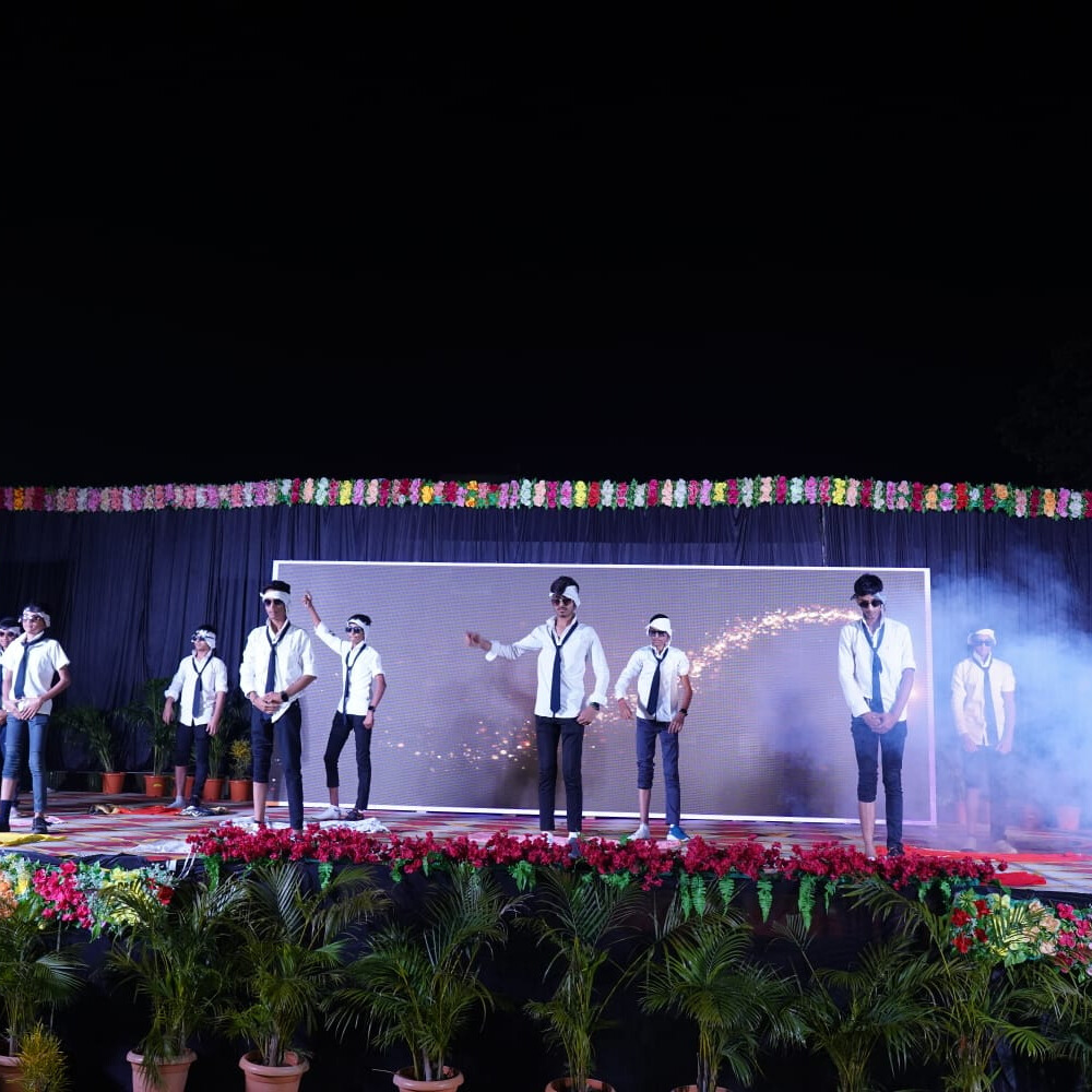 Students performing musical pieces on stage with a live audience at the school music concert.