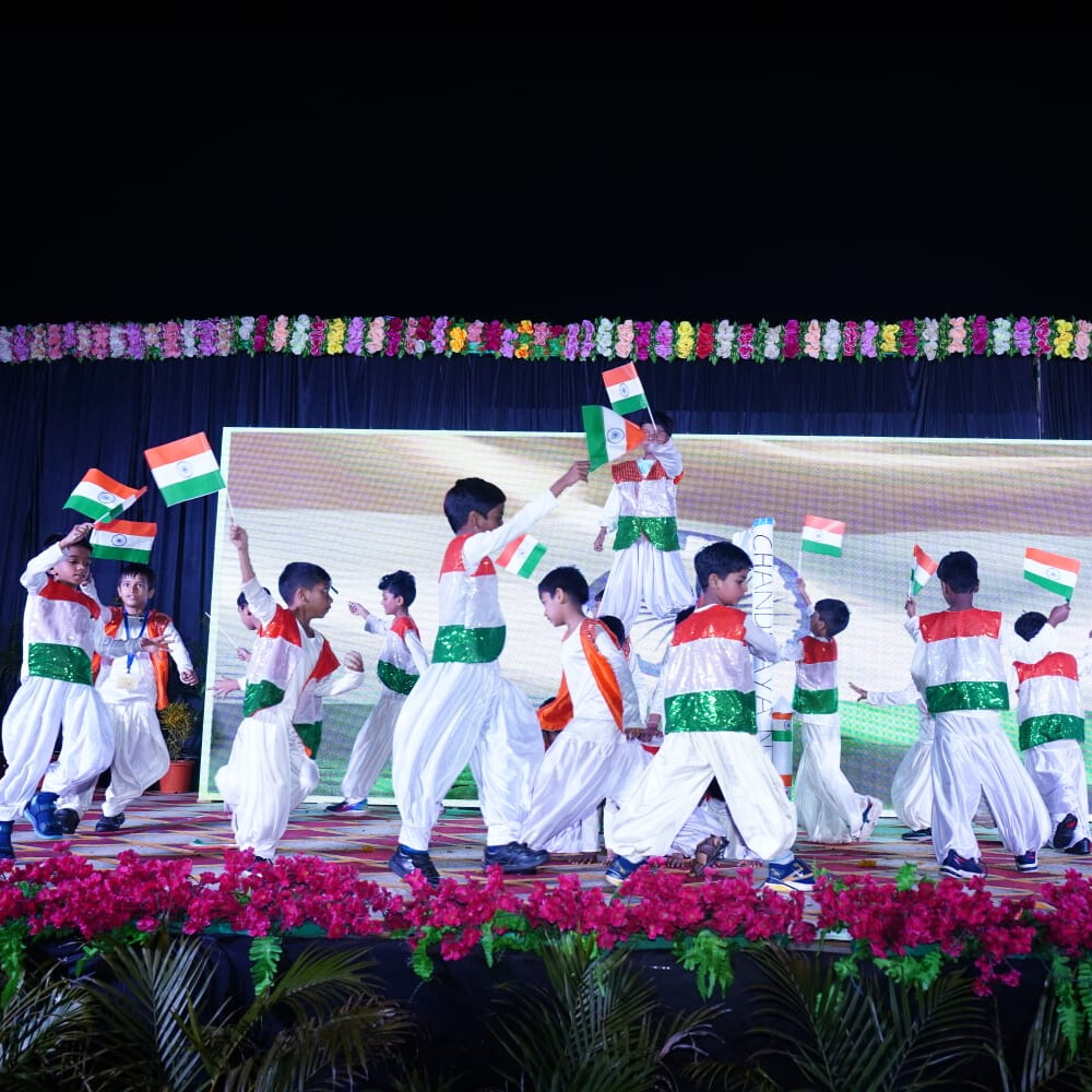 Students performing musical pieces on stage with a live audience at the school music concert.